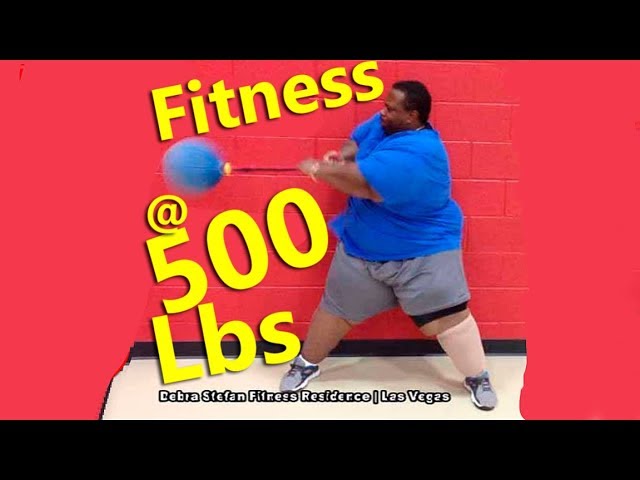 Man weighing 500 pounds performing a medicine ball exercise during personalized fitness coaching