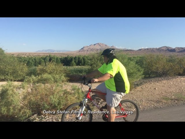 Adult participant biking on a Nevada desert trail during an outdoor fitness for weight loss program